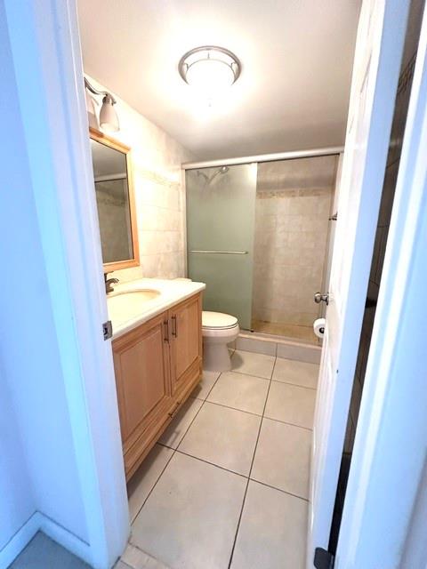 10777 West Sample Road, Unit 418 Coral Springs, FL 33065 - Photo 19 of 21 a bathroom with a granite countertop sink a mirror and a toilet