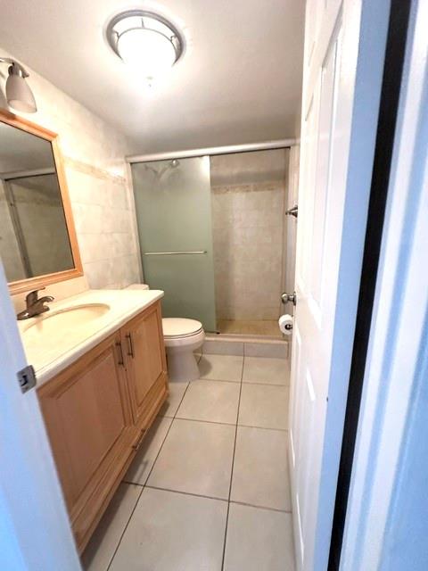 10777 West Sample Road, Unit 418 Coral Springs, FL 33065 - Photo 20 of 21 a bathroom with a sink a toilet a mirror and vanity