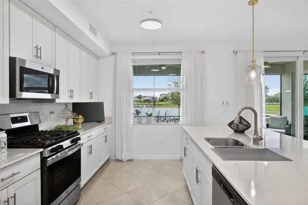 a kitchen with a sink stove top oven and cabinets