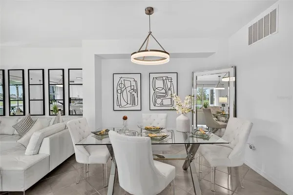 a living room with furniture a window and a chandelier