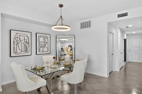 a view of a dining room with furniture and chandelier
