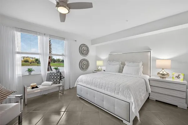 a bedroom with a bed and a large window