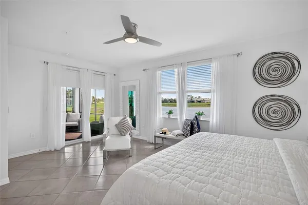 a bedroom with a bed and glass window