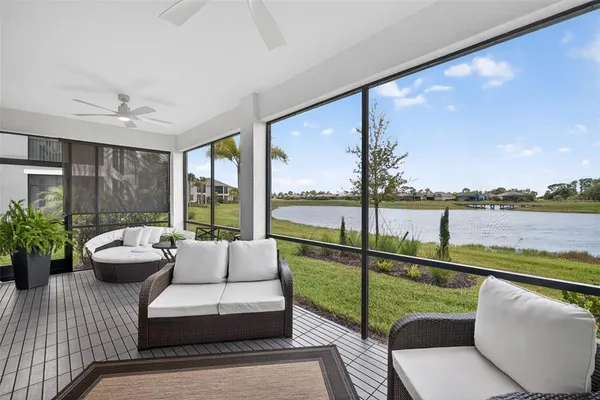 a balcony with furniture and a view of lake
