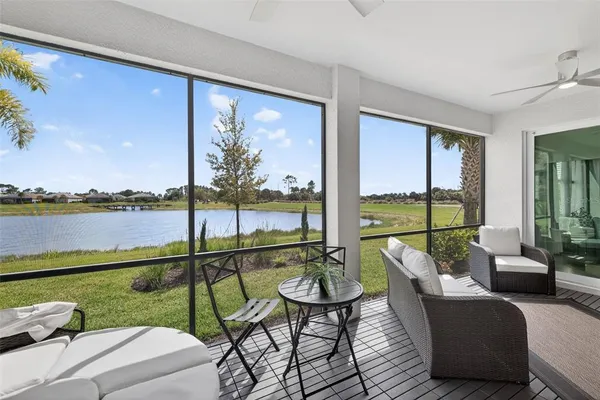 a balcony with furniture and view of lake