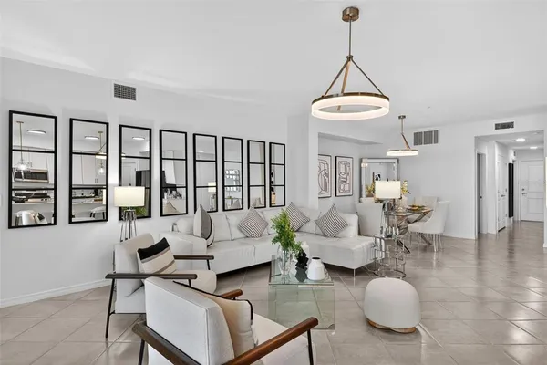 a living room with furniture and a dining table with wooden floor