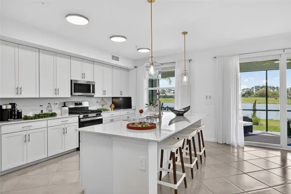 a kitchen with stainless steel appliances kitchen island granite countertop a sink and cabinets