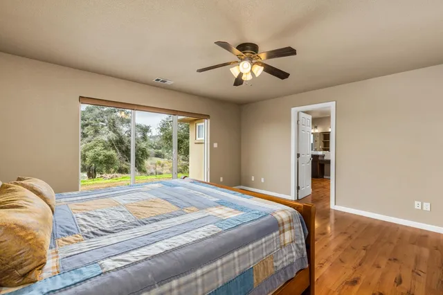 a bedroom with a large bed and a window