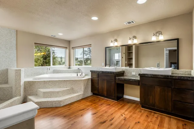 a large bathroom with a large tub and sink