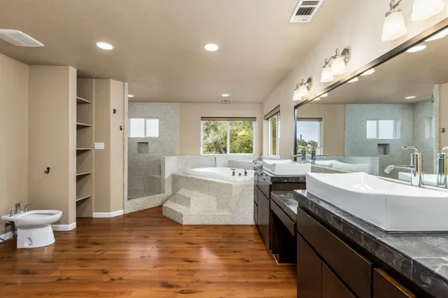 a large white kitchen with a stove a sink dishwasher and a refrigerator