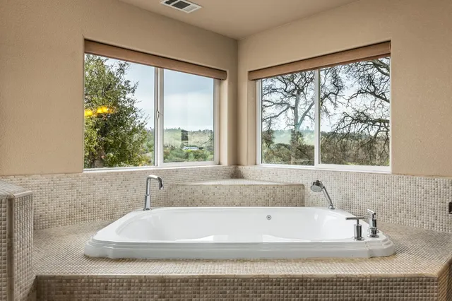 a bathroom with a bathtub and window