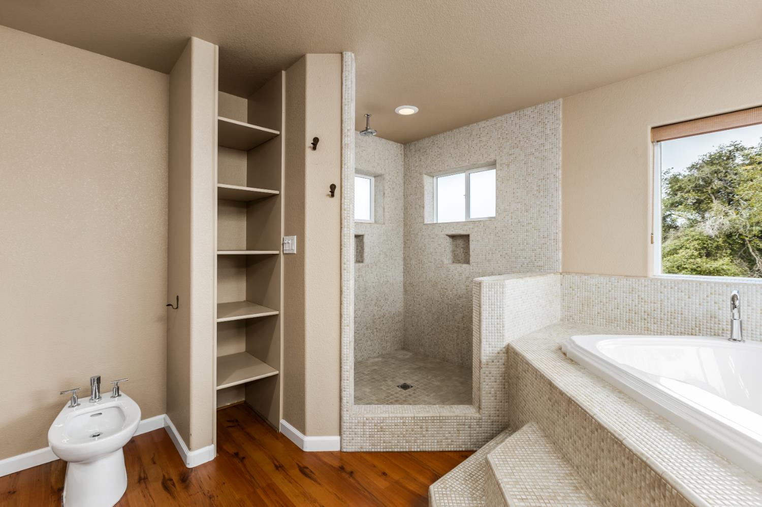 20839 Bear Hollow Road Grass Valley, CA 95949 - Photo 25 of 44 Large walk in shower with shower head on ceiling and wall. Toilet to left of bidet