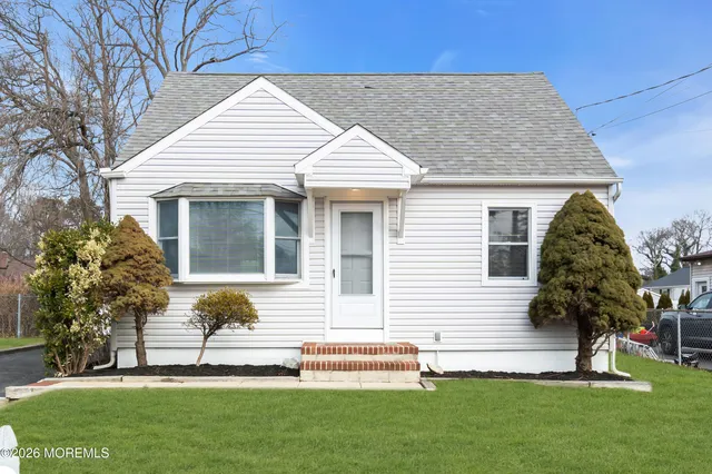 a front view of a house with a garden and plants