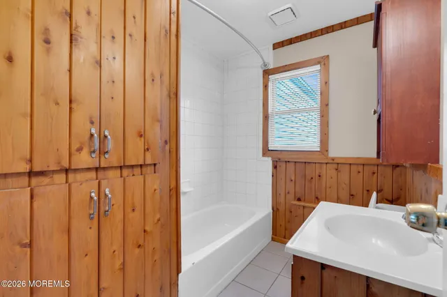 a bathroom with a sink a vanity and a bathtub