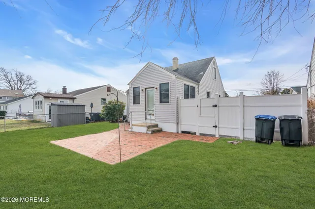 a view of a house with a backyard and a patio