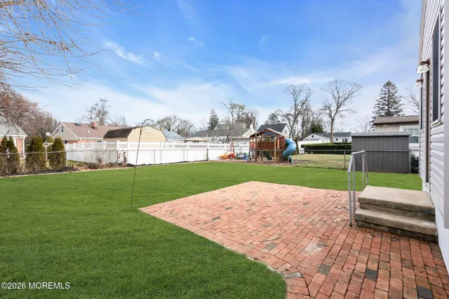 a view of yard with swimming pool and green space