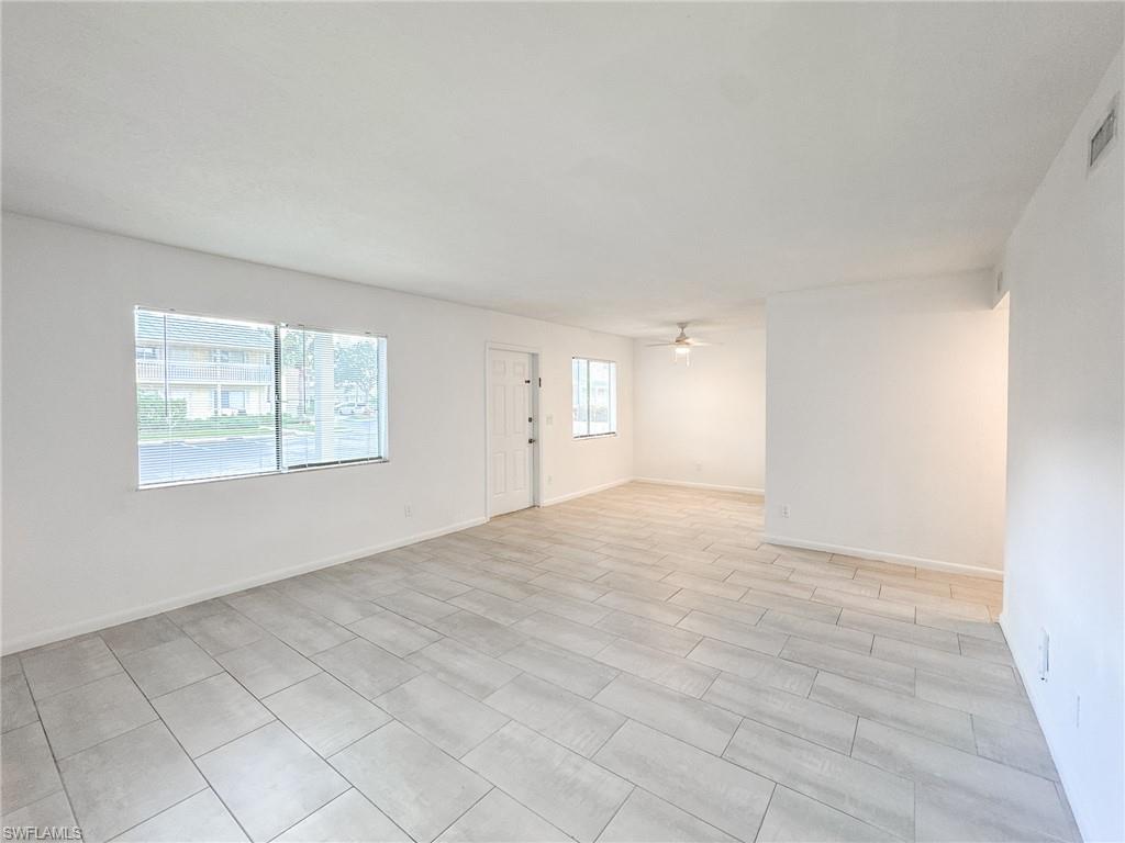 4631 Bayshore Drive, Unit L2 Naples, FL 34112 - Photo 12 of 41 an empty room with windows