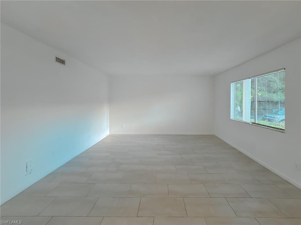 4631 Bayshore Drive, Unit L2 Naples, FL 34112 - Photo 13 of 41 an empty room with windows