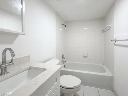 a bathroom with a sink toilet and bathtub