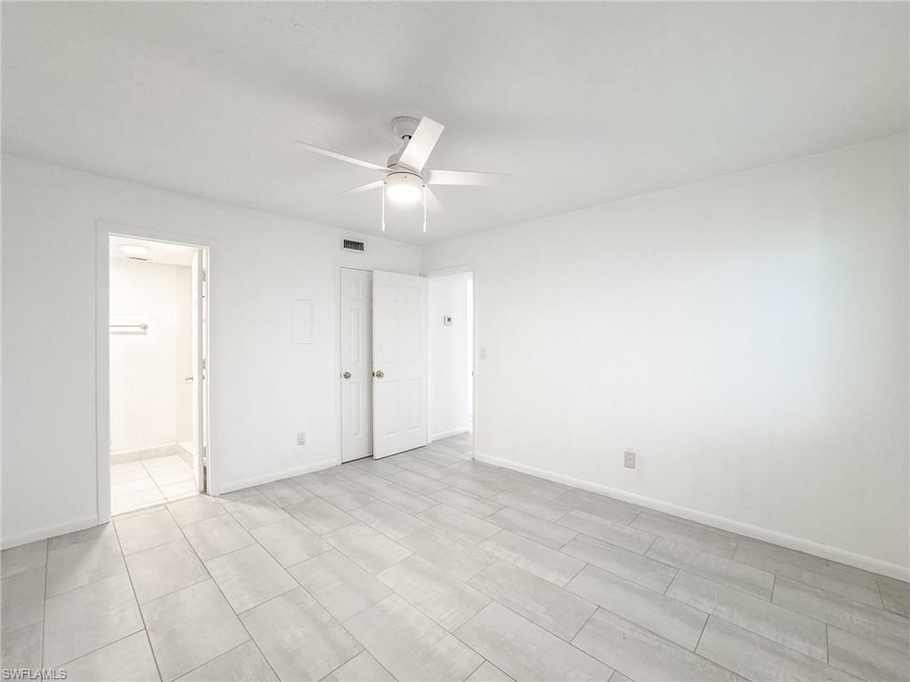 4631 Bayshore Drive, Unit L2 Naples, FL 34112 - Photo 19 of 41 an empty room with an entryway and fan