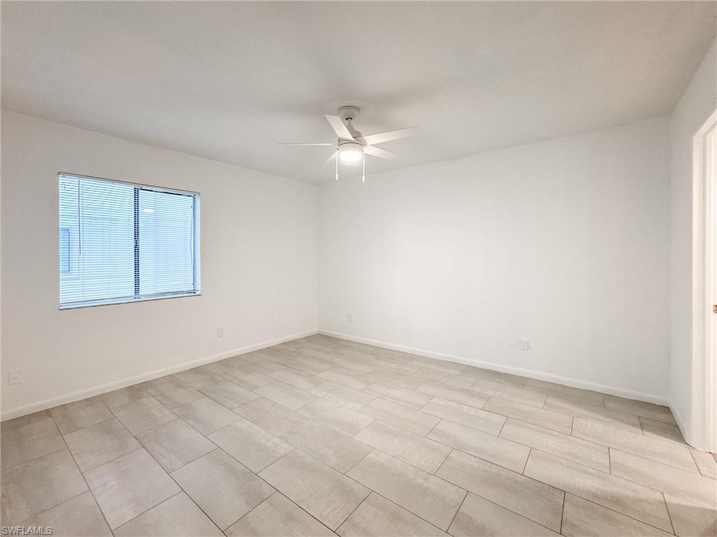 4631 Bayshore Drive, Unit L2 Naples, FL 34112 - Photo 24 of 41 an empty room with a ceiling fan and a window