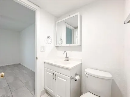 a bathroom with a sink toilet and mirror