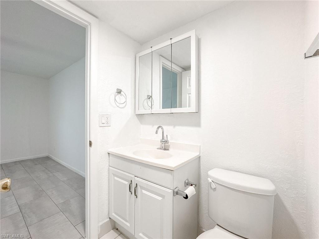 4631 Bayshore Drive, Unit L2 Naples, FL 34112 - Photo 26 of 41 a bathroom with a sink toilet and mirror