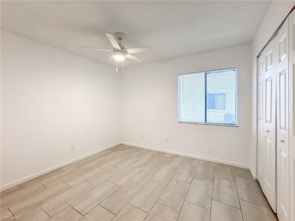 4631 Bayshore Drive, Unit L2 Naples, FL 34112 - Photo 27 of 41 an empty room with a ceiling fan and a window