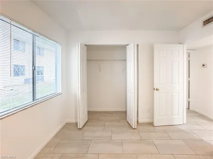 a view of a livingroom with an empty space and a window