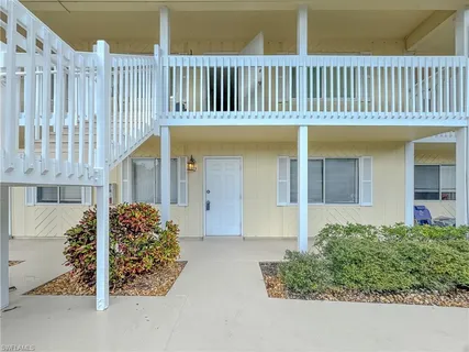 a view of a house with wooden fence