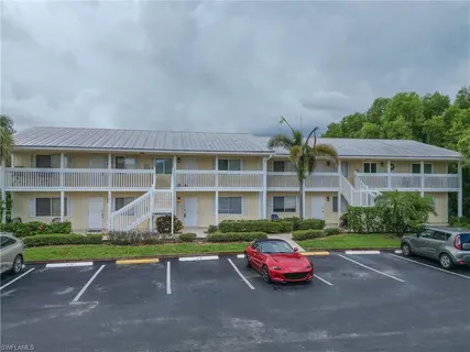 a front view of a house with a yard fire pit and outdoor seating