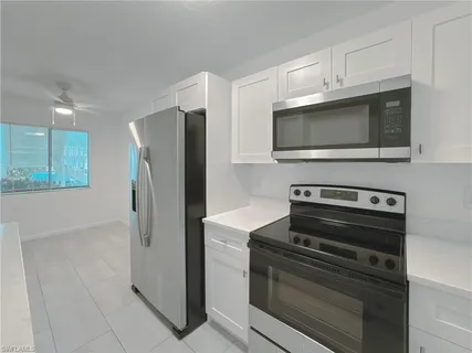 a kitchen with cabinets and stainless steel appliances