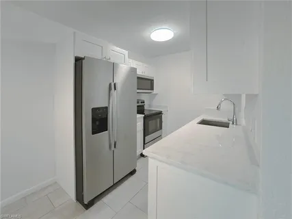 a kitchen with stainless steel appliances a refrigerator and a sink