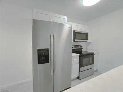 a kitchen with stainless steel appliances a refrigerator and a stove top oven