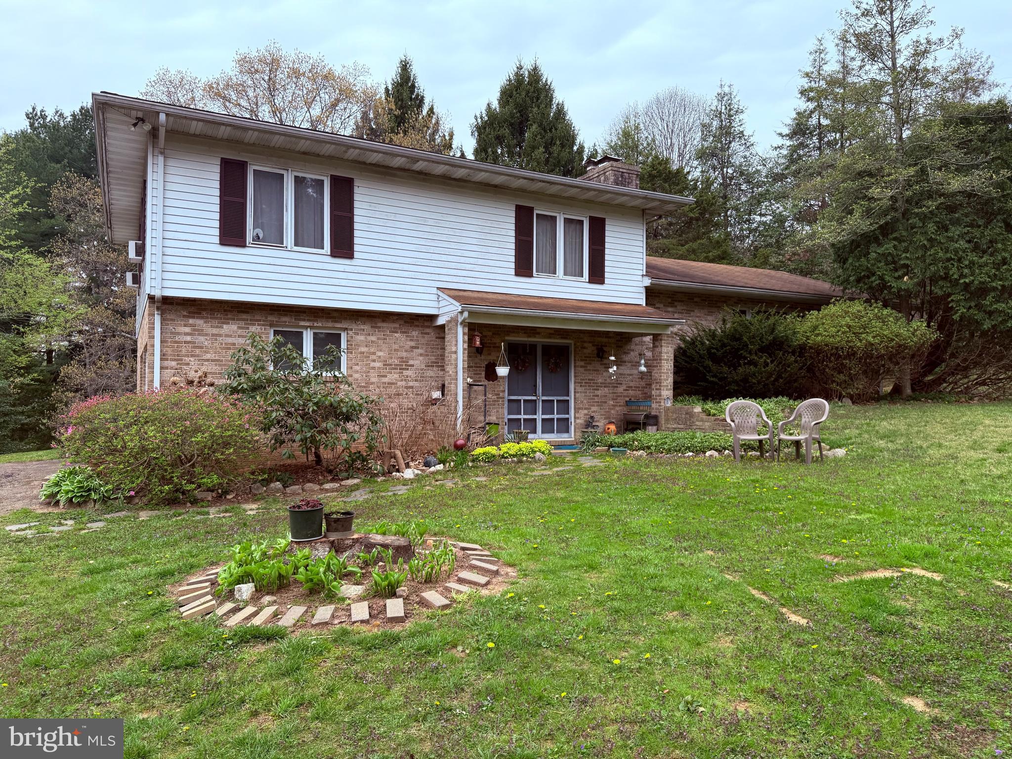 a front view of a house with a garden