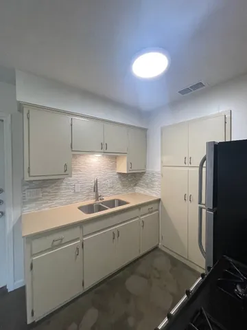 a kitchen with a sink stainless steel appliances and cabinets