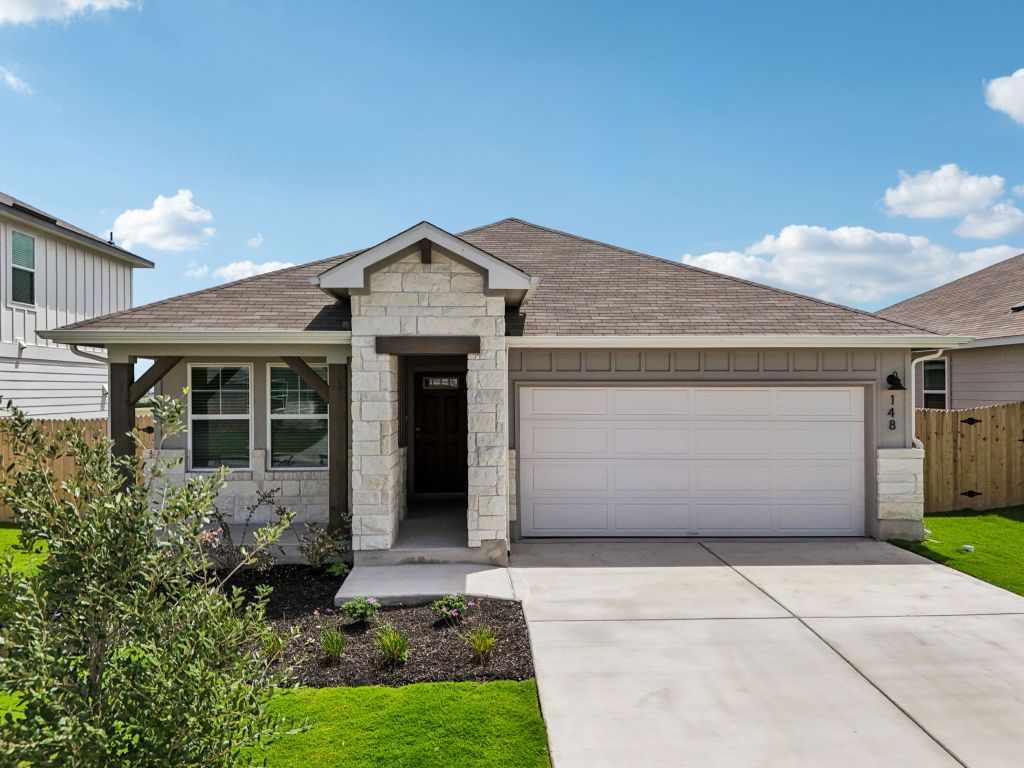 Ranch-style house featuring an attached garage, roof with shingles, stone siding, and concrete driveway