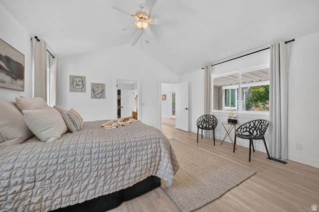 1979 Cave Hollow Way Bountiful, UT 84010 - Photo 21 of 59 Spacious bedroom featuring vaulted ceilings, a ceiling fan with integrated lighting, wood-finish flooring, and a large window with white trim