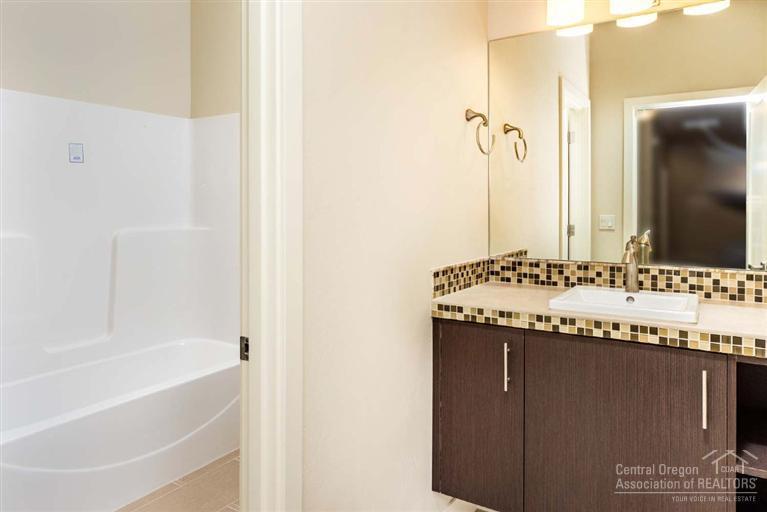 61515 Southwest Blakely Road Bend, OR 97702 - Photo 8 of 20 a bathroom with a granite countertop sink and a mirror