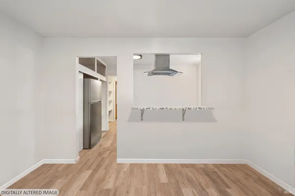 a view of a room with wooden floor and staircase