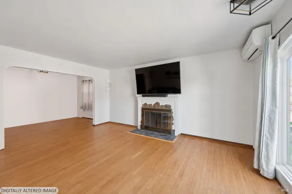 a view of a livingroom with furniture and a flat screen tv