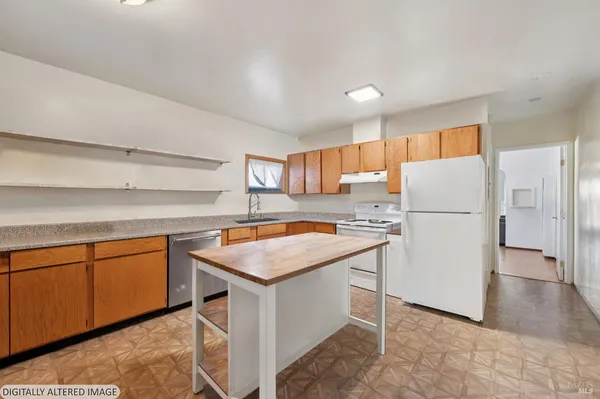 a kitchen with stainless steel appliances granite countertop a refrigerator a sink dishwasher a stove with white cabinets and wooden floor