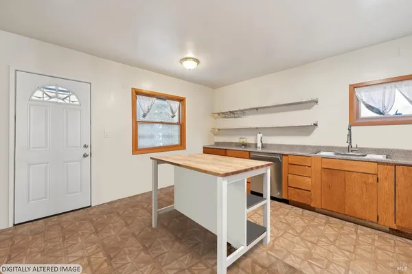 a kitchen with granite countertop cabinets stainless steel appliances and a sink