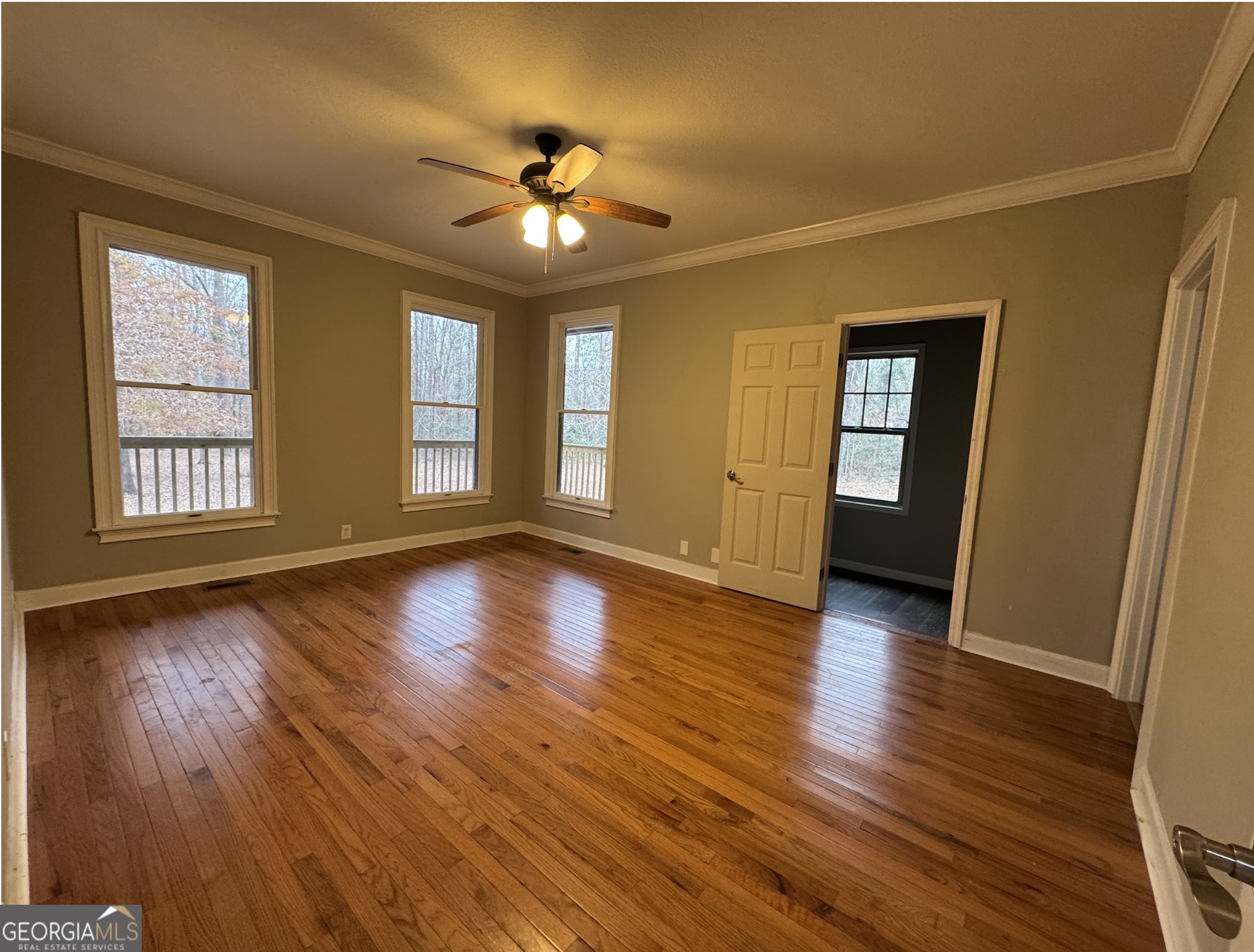 1206 Jasmine Road Dublin, GA 31021 - Photo 14 of 33 a view of an empty room with wooden floor and a window