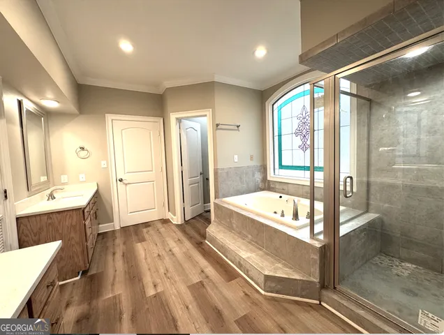 a spacious bathroom with a tub shower and sink