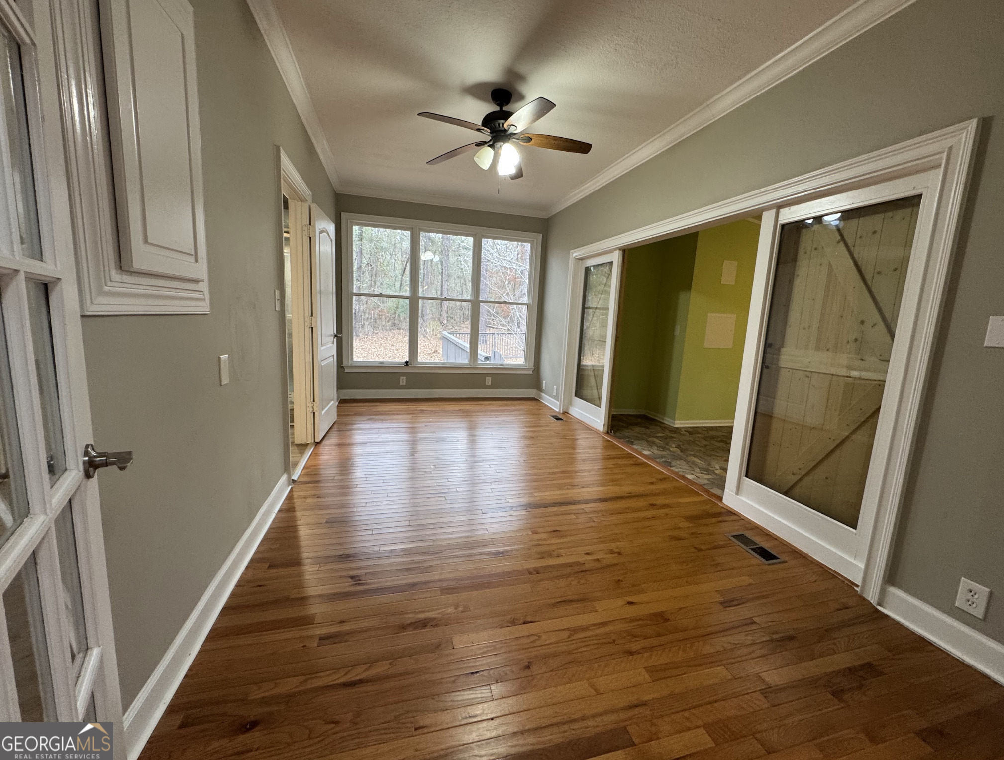 1206 Jasmine Road Dublin, GA 31021 - Photo 21 of 33 wooden floor in an empty room with a window