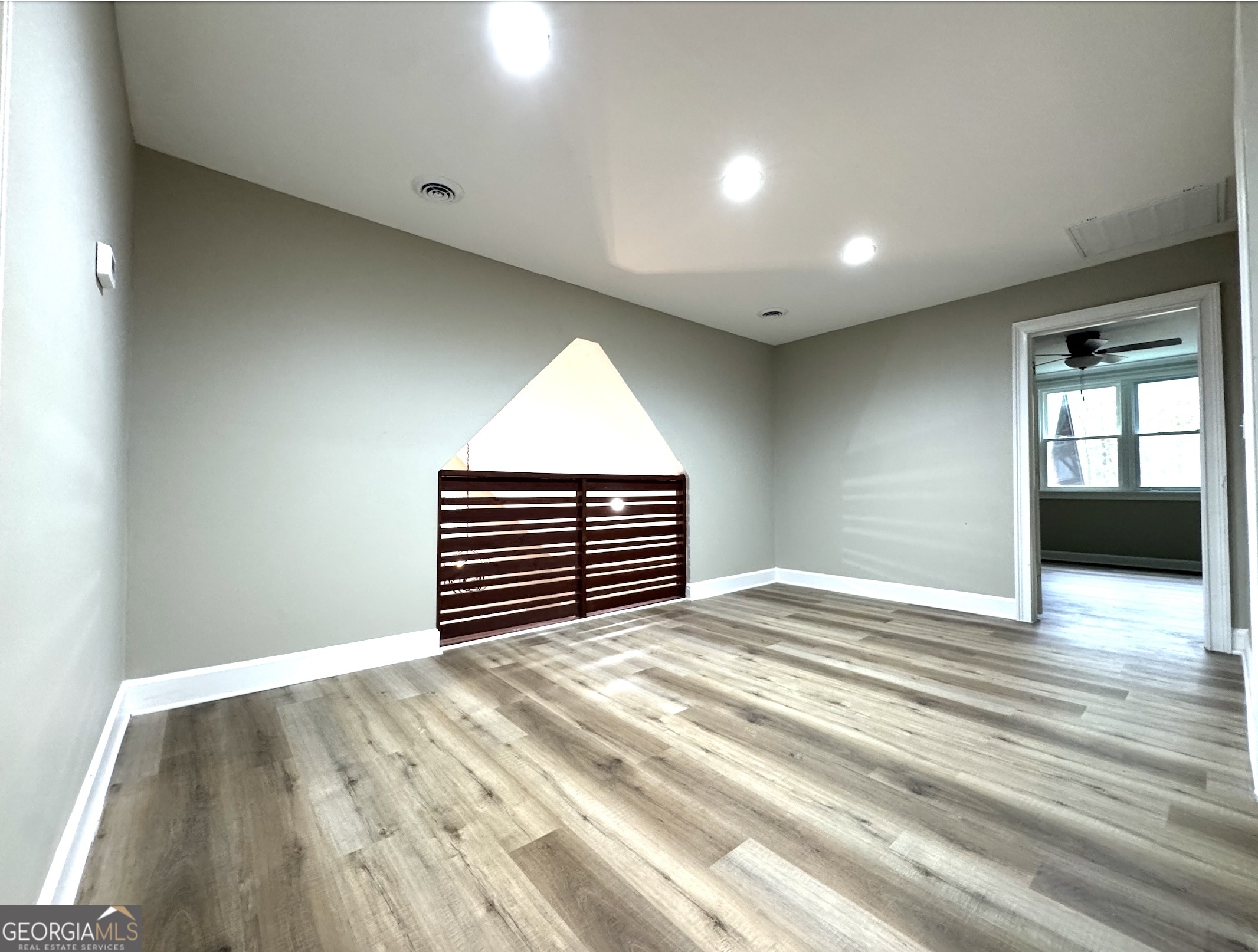 1206 Jasmine Road Dublin, GA 31021 - Photo 23 of 33 a view of empty room with wooden floor and fan