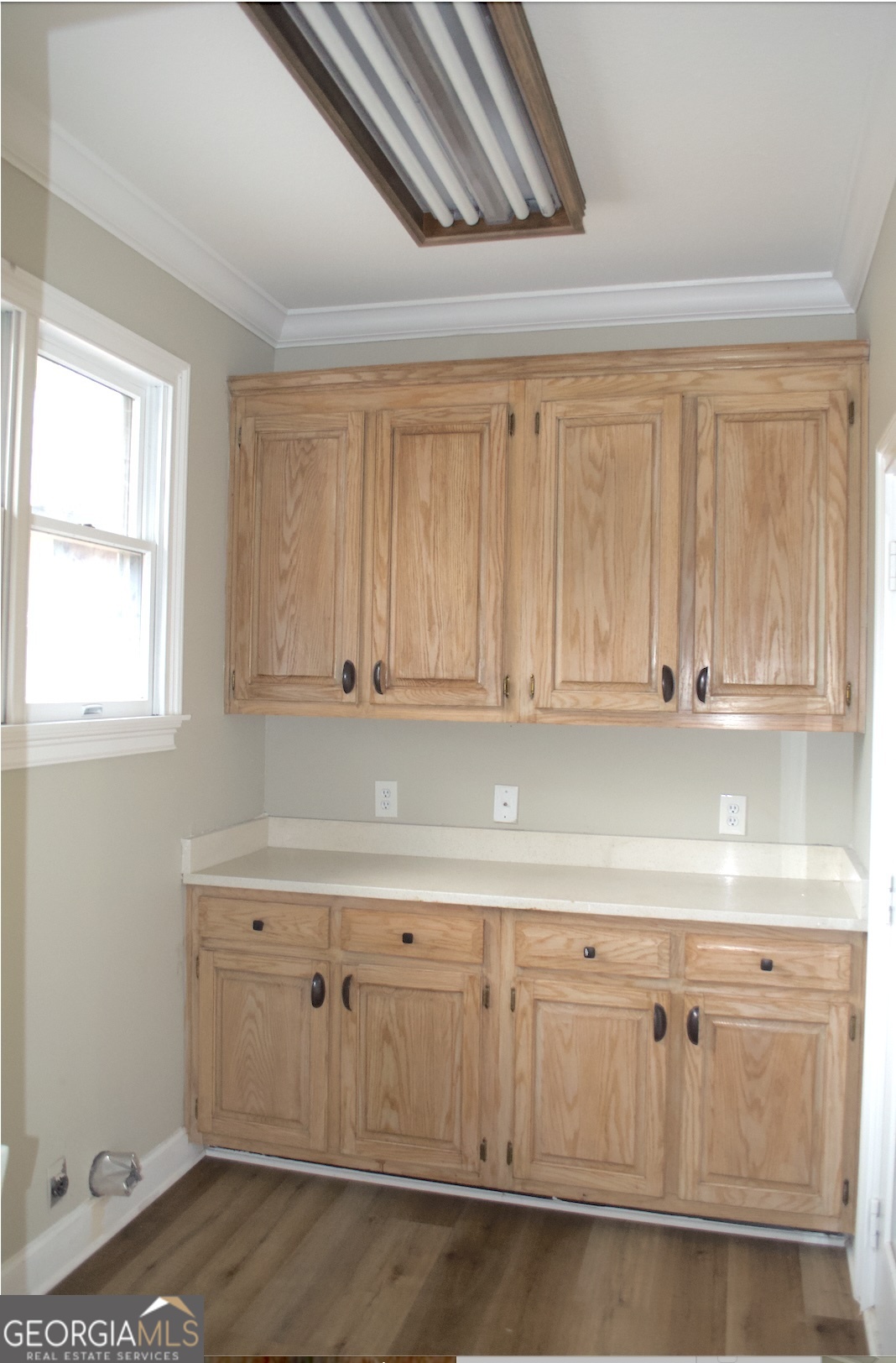 1206 Jasmine Road Dublin, GA 31021 - Photo 25 of 33 a kitchen with white cabinets and a window