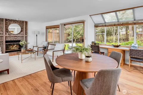 a living room with furniture a fireplace and a large window