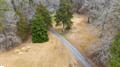 5754 Highway 20 Due West, SC 29639 - Photo 2 of 15 This scenic aerial view captures a serene winding driveway nestled among a verdant landscape.